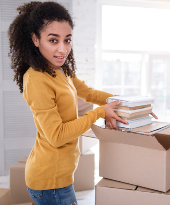 Woman packing books into moving box