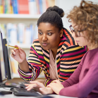 Woman consults with academic advisor in school library